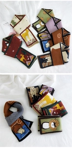 Detailed view of various knitted winter scarves with cartoon reindeer and animal patterns