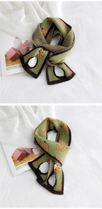 Macro view of grass green knitted scarf with pineapple jacquard and striped edge detail