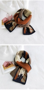 Detail showing the thick knit texture with geometric color blocks and cartoon elk pattern