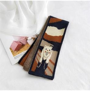 Detailed knit texture of cartoon cat scarf with artistic color-block patterns and soft yarn