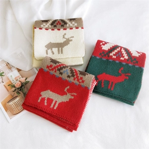 Christmas knit scarves with reindeer and geometric patterns in red, green and beige
