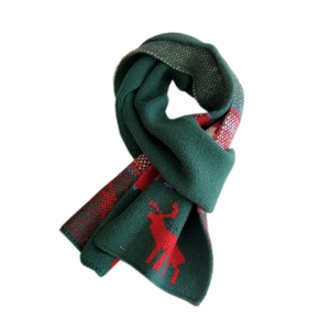 Green Christmas knit scarf with red reindeer patterns and soft festive texture