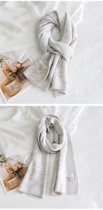 Détails de maille douce et étiquette de marque sur une longue écharpe d'hiver beige