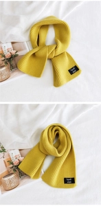 Close-up of a yellow ribbed knit scarf showing texture and small brand label details