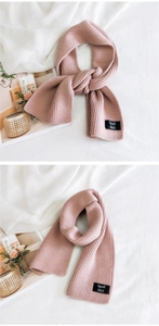Detail of lotus pink ribbed knit scarf with a woven Spall ébit square brand label