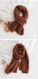 Detail of thick caramel knit scarf showing chunky weave texture and warm material