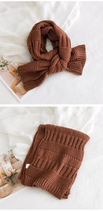 Close-up of thick brown chunky knit scarf showing ribbed texture and warm material