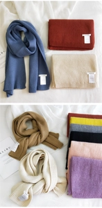 Close-up of thick knit scarves in various colors with textured ribbed pattern detail