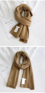 Close-up of thick brown rib-knit scarf texture showing high-quality wool yarn detail