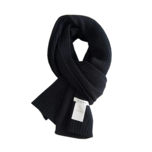 Classic black knitted scarf for women and men featuring thick rib-knit texture and logo label