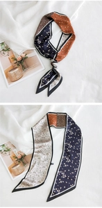 Détail d'un élégant foulard en soie avec motifs floraux et pois sur tissu blanc texturé