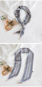 Détail d'un foulard twilly géométrique avec motif à chevrons bleus et pointes biseautées