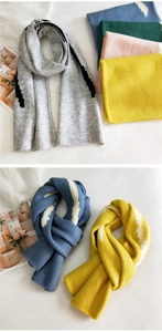 Close-up of thick knitted striped scarf showing soft wool texture and colorful yarn detail