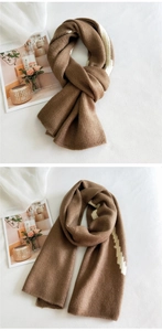 Close-up of thick winter knit scarf with brown and white zigzag pattern detail