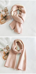 Detailed macro view of soft pink and cream striped knit texture on a long winter scarf