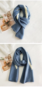 Detailed close-up of dark blue and white striped knit scarf showing thick woven texture