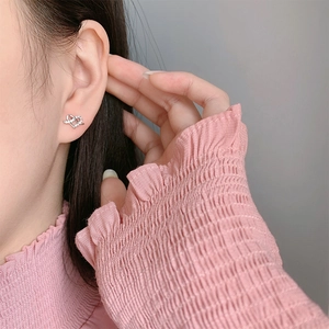 Elegant S925 sterling silver heart stud earrings with cubic zirconia on model