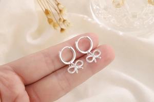 Detail of S925 sterling silver bow drop earrings showing the hallmark on the hoop