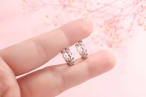 Close-up of S925 sterling silver hollow heart hoop earrings with a polished finish
