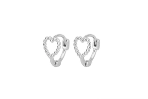 Détail macro des créoles en forme de cœur perlé en argent S925 sur fond blanc immaculé