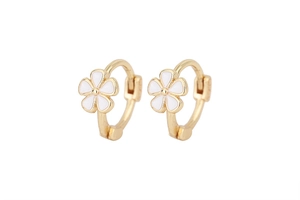Detailed macro view of small gold floral hoop earrings with white enamel flower charms