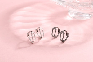 Detail shot of S925 sterling silver stamp on minimalist pin-shaped safety pin earrings