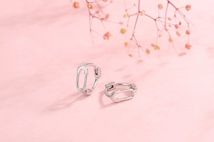 Close-up of S925 sterling silver hallmark on creative safety pin earring jewelry