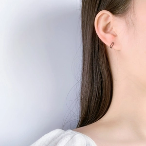 Minimalist S925 sterling silver safety pin earring in black worn by a male model