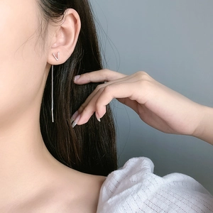 Close-up of minimalist V-letter drop ear threader on model for a sleek trendy look