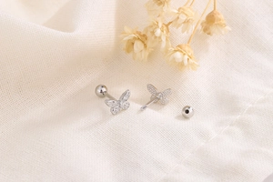 Detailed close-up of sterling silver butterfly screw back earrings with textured wings