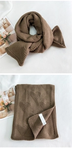 Close-up of thick knitted coffee brown scarf with embossed heart pattern and soft texture