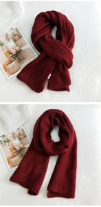 Detailed macro view of burgundy chunky knit scarf featuring a thick geometric texture