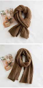 Close-up of thick brown knit scarf featuring classic cable pattern for winter warmth