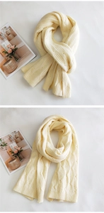 Detail of cream cable-knit scarf showing vintage textured weave and soft thick wool fabric