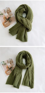 Detailed view of green cable-knit wool scarf texture on a minimalist background