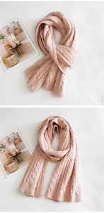 Close-up of pink cable knit texture on thick winter scarf with soft wool pattern