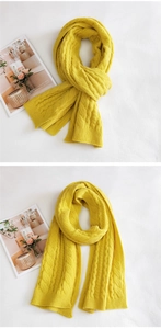 Detail of bright yellow chunky cable knit scarf showing thick soft texture and knitting