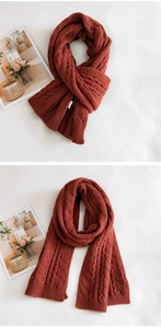 Detail of chunky knit scarf showing thick cable weave texture and soft ribbed edges