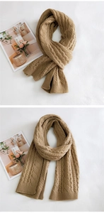 Detail of cable-knit texture and ribbed edges on a thick khaki winter scarf with magazine