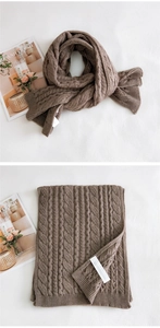 Detail of brown cable knit scarf showing thick wool texture and authentic care label