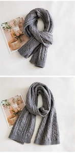Detailed cable knit texture and ribbed edge of this warm gray winter scarf
