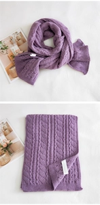 Detail of purple chunky cable knit scarf with thick texture and white wash label