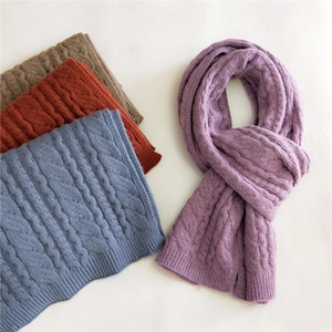 Thick cable-knit solid color scarves in purple, blue, red, and brown on a white background