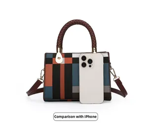 Size comparison of geometric pattern handbag with a white iPhone showing product dimensions