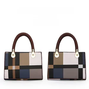 Detail showing two plaid handbags with top handles and golden metallic hardware parts