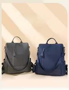 Detail view of anti-theft backpacks in dark grey and navy blue with lychee texture