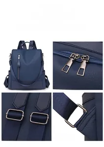 Detail view of double zippers, adjustable straps and metallic hardware on navy PU backpack