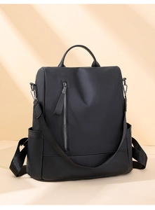 Detail of black PU leather backpack with vertical metal zipper and adjustable straps