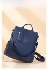 Detail of blue PU leather backpack with side pockets and smooth litchi texture finish