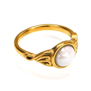 Retro titanium steel gold ring featuring a large round white ceramic inlay and carved band